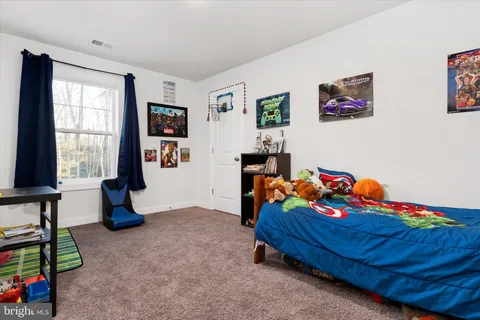 a bedroom with furniture and a wooden floor
