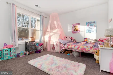a view of room with baby crib and cabinet