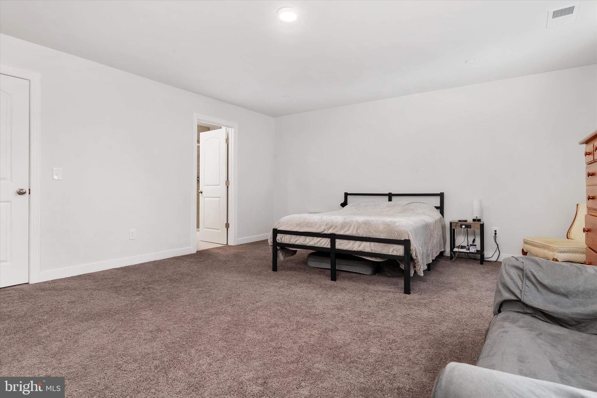 720 Bridge Drive Pasadena, MD 21122 - Photo 27 of 46 a bedroom with a bed and a couch