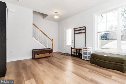 a living room with furniture and a ceiling fan