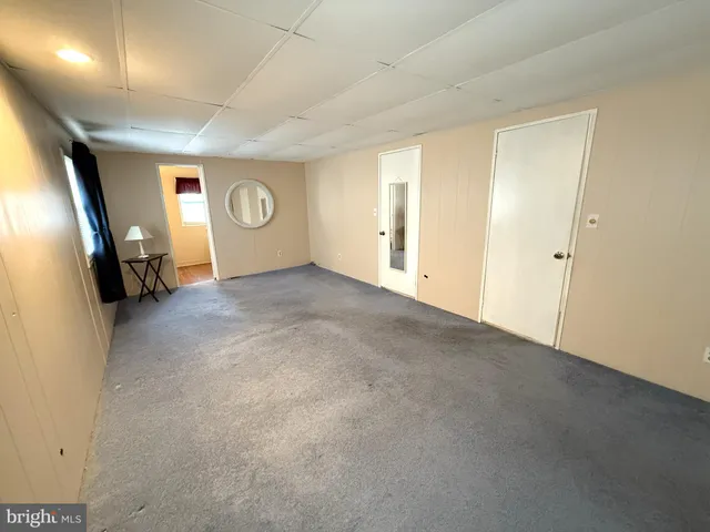 a view of a livingroom with wooden floor and window
