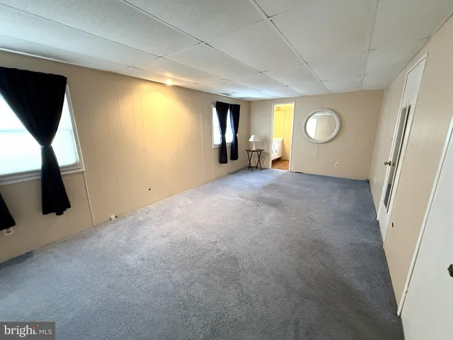 a view of hallway with stairs and a window