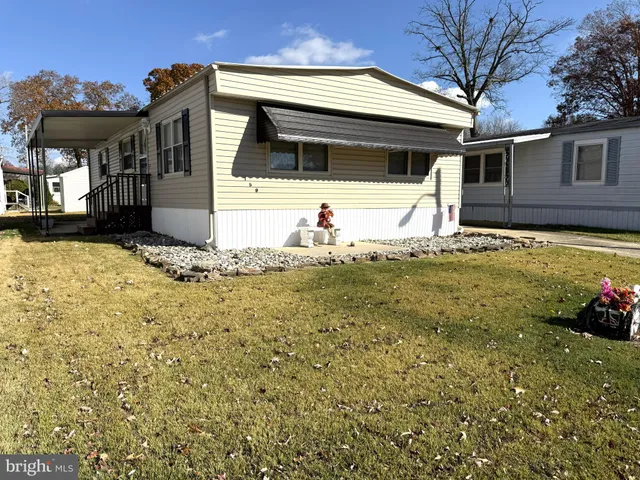 a view of the house with a yard