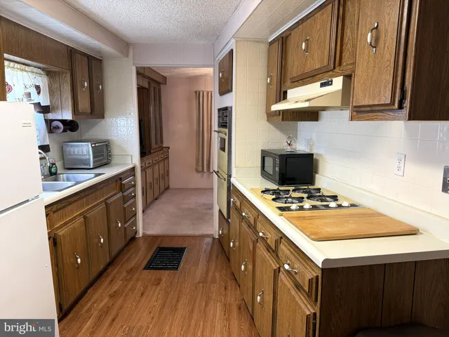 a kitchen with a stove and a refrigerator
