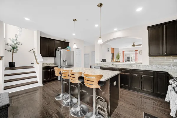 a large kitchen with a table and chairs
