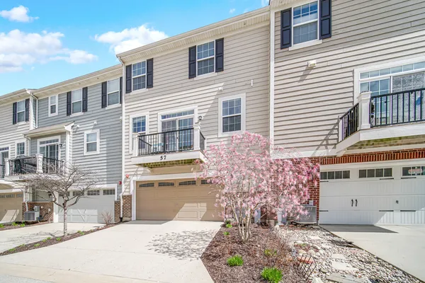 a view of a house with a yard and sitting area