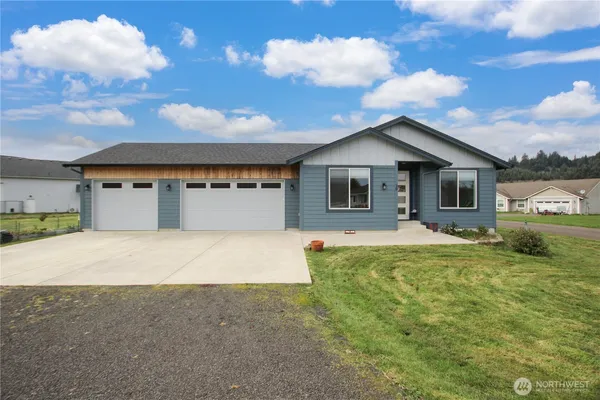 a front view of a house with a yard garage and outdoor seating