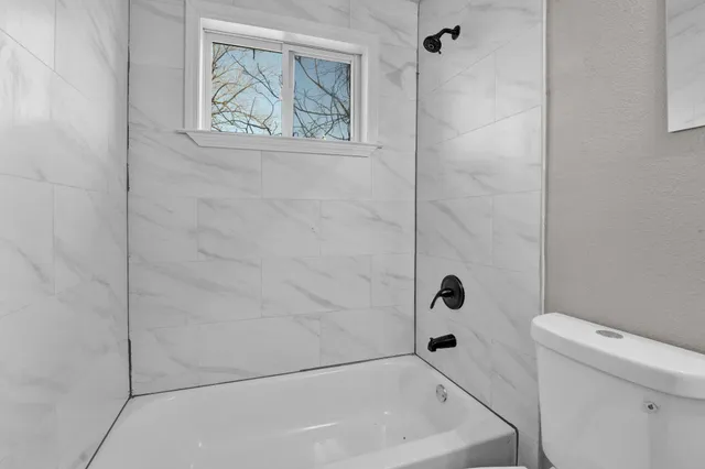 a view of a room with wooden floor and windows