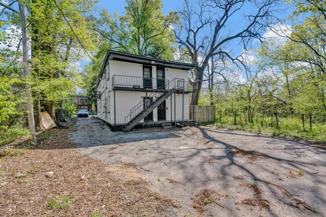 a view of a house with a large tree