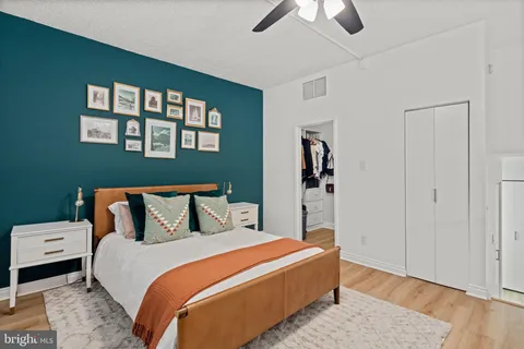 a bedroom with a bed and wooden floor