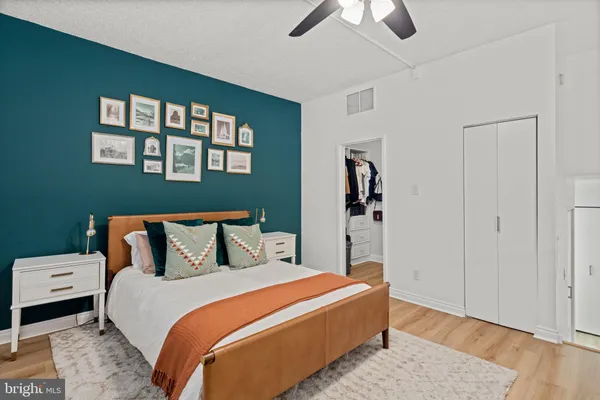 a bedroom with a bed and wooden floor