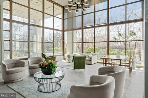a living room with furniture and a large window with garden view