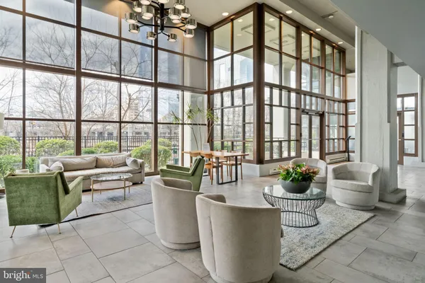 a living room with furniture and potted plants