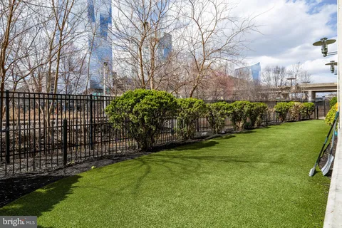 a view of a park with iron fence