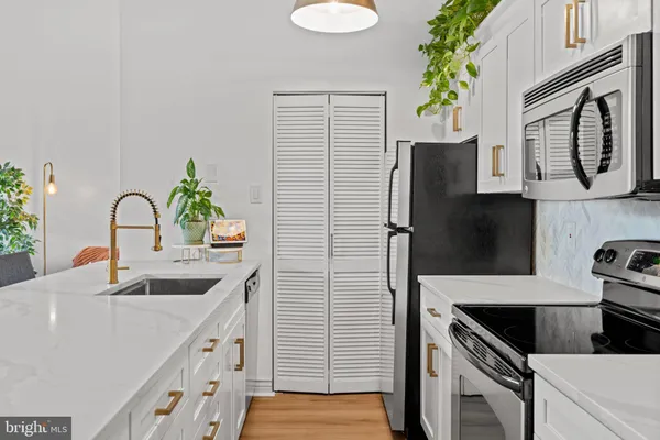 a kitchen with a sink and a refrigerator