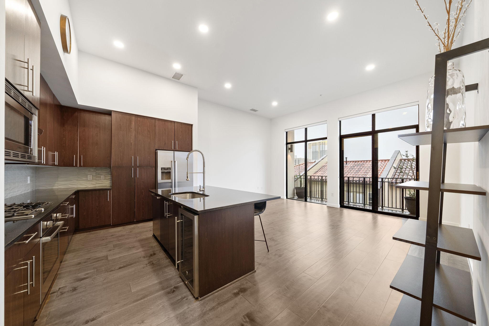 a kitchen with stainless steel appliances granite countertop a stove and a wooden floors