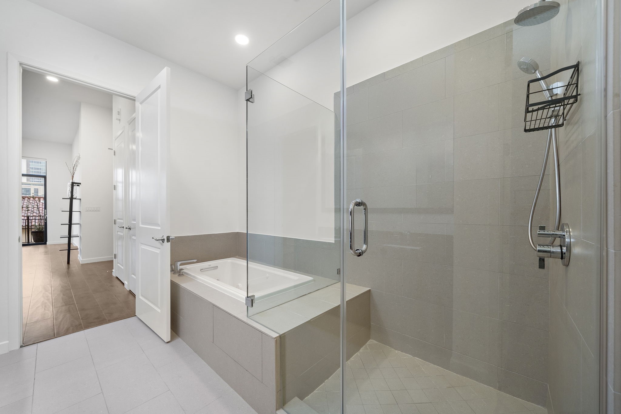 4820 Caroline Street, Unit 507 Houston, TX 77004 - Photo 18 of 20 a bathroom with a tub a sink and a shower