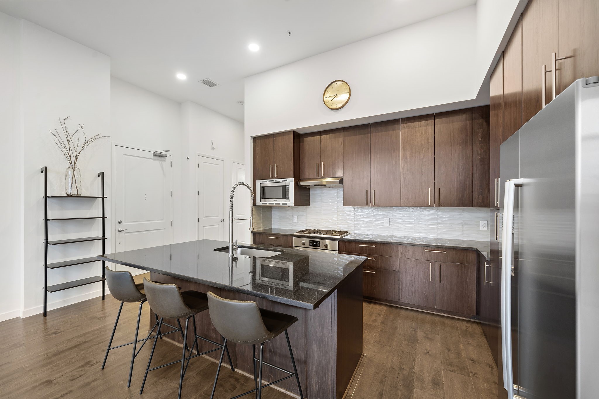 4820 Caroline Street, Unit 507 Houston, TX 77004 - Photo 7 of 20 a kitchen with stainless steel appliances granite countertop a kitchen island a stove and a refrigerator