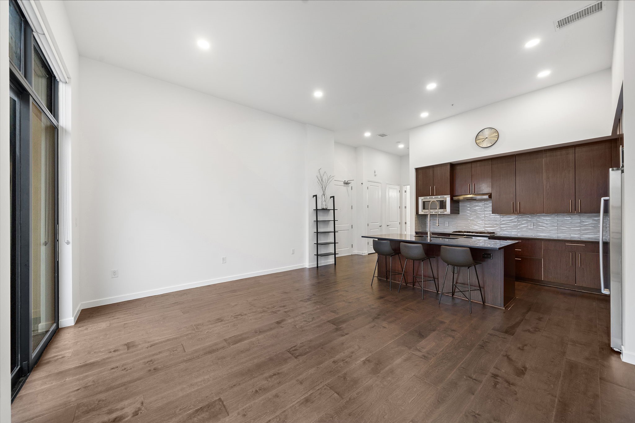 4820 Caroline Street, Unit 507 Houston, TX 77004 - Photo 8 of 20 a view of kitchen with kitchen island stainless steel appliances refrigerator stove microwave and cabinets