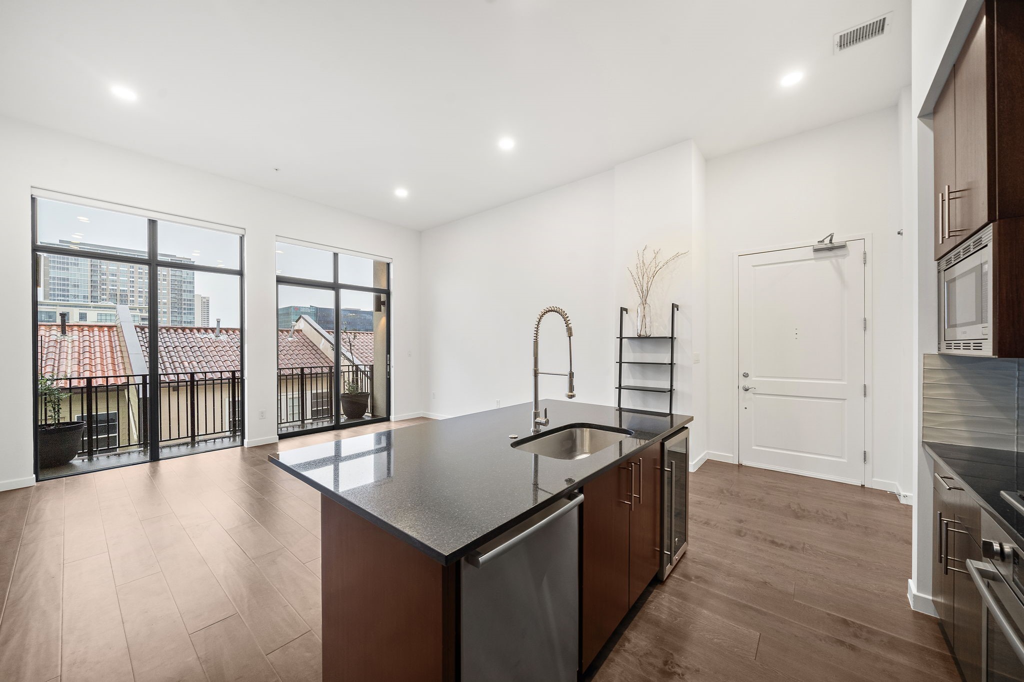 4820 Caroline Street, Unit 507 Houston, TX 77004 - Photo 9 of 20 a kitchen with stainless steel appliances granite countertop a sink and a wooden floors