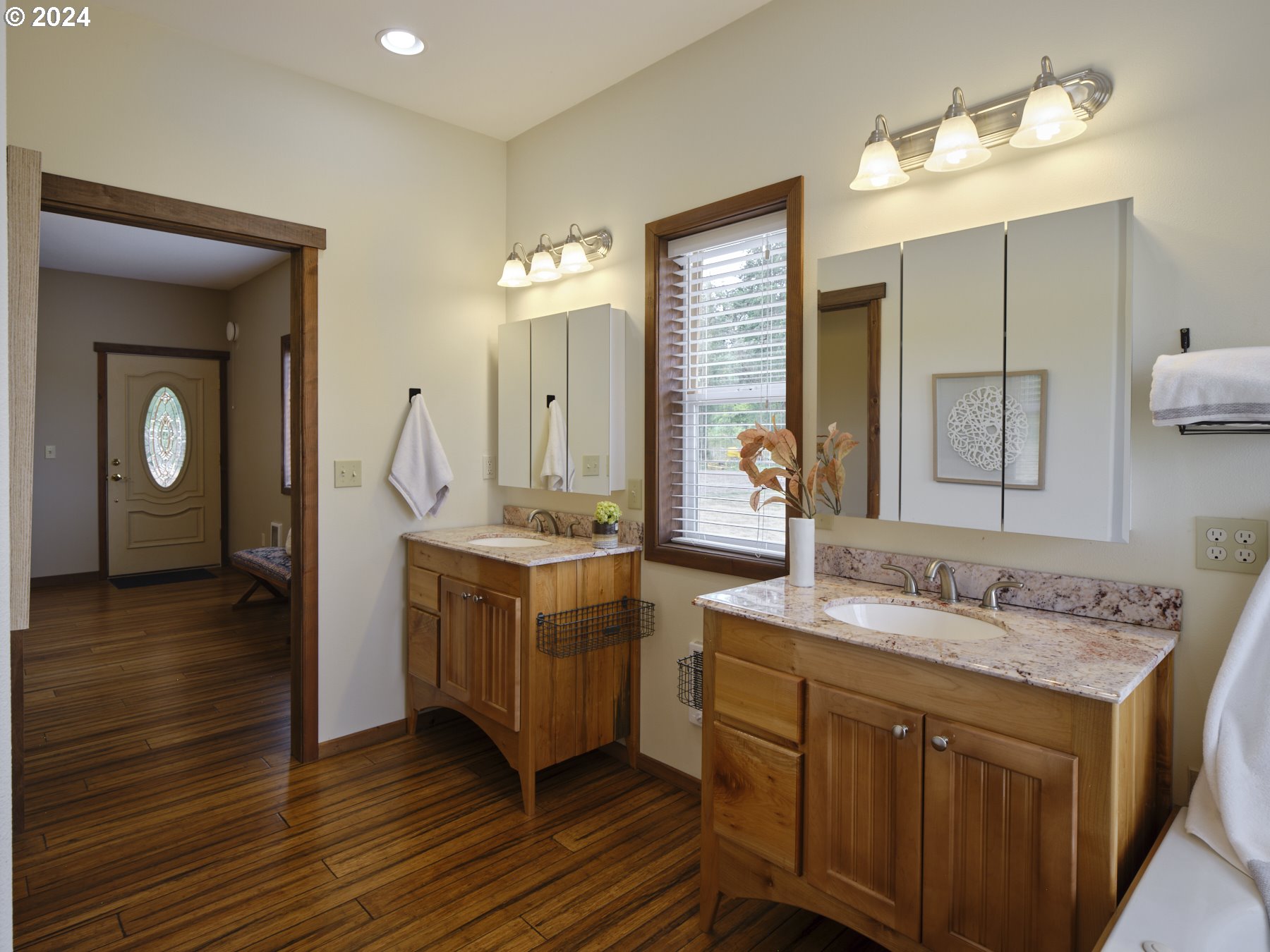 29902 Northwest 51st Avenue Ridgefield, WA 98642 - Photo 22 of 46 a bathroom with a granite countertop sink and a mirror