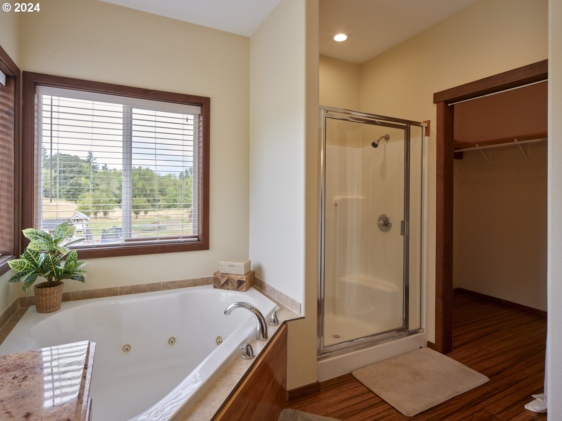 29902 Northwest 51st Avenue Ridgefield, WA 98642 - Photo 23 of 46 a bathroom with a tub shower and window