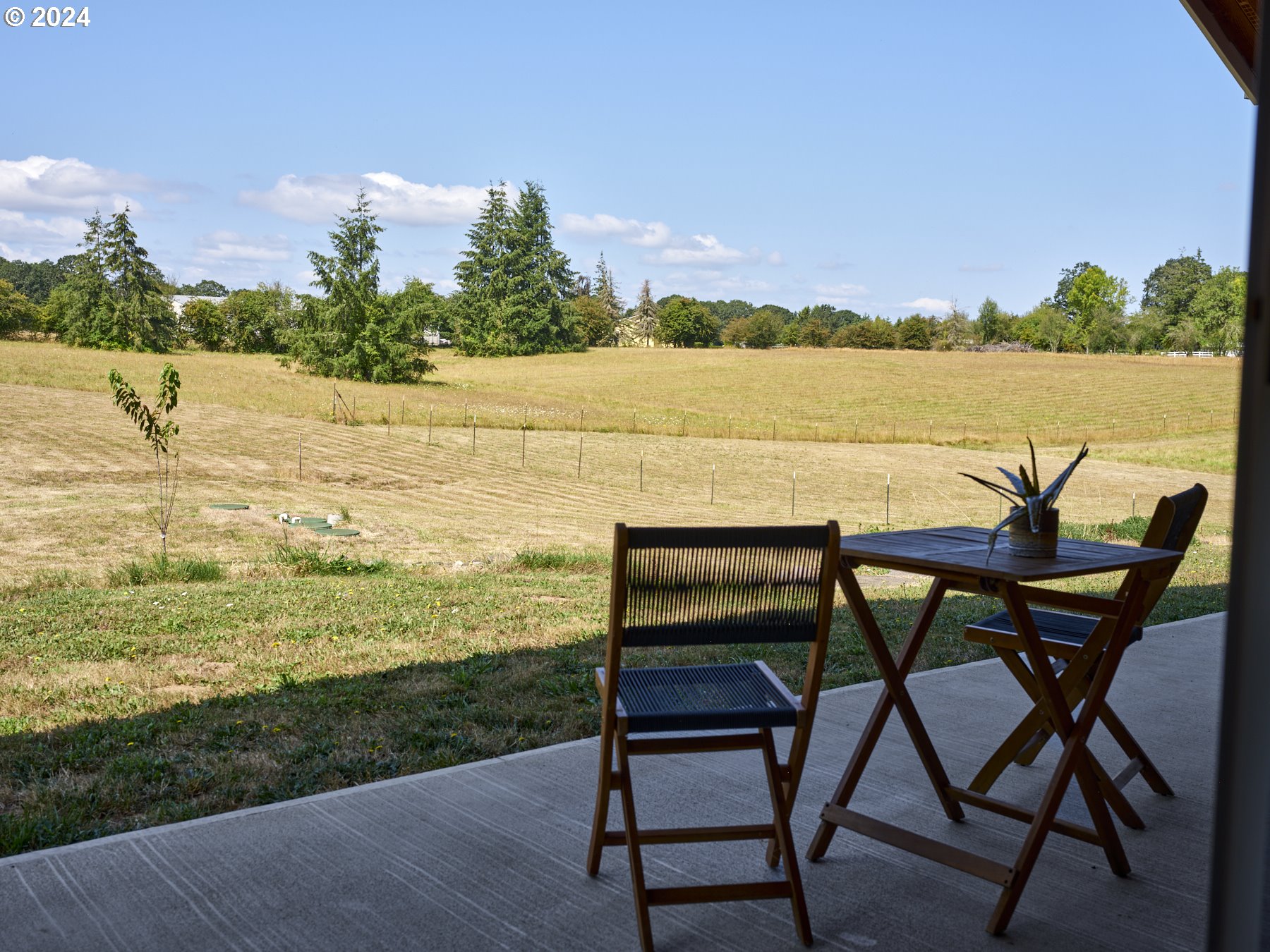 29902 Northwest 51st Avenue Ridgefield, WA 98642 - Photo 29 of 46 a view of a lake with table and chairs