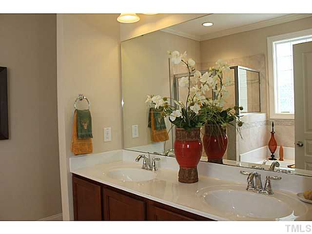 1137 Chapanoke Road Raleigh, NC 27603 - Photo 3 of 19 a bathroom with a sink a vanity and a mirror