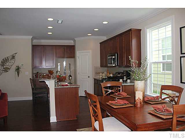 1137 Chapanoke Road Raleigh, NC 27603 - Photo 6 of 19 a kitchen with stainless steel appliances granite countertop wooden cabinets a stove top oven a granite counter space and a window