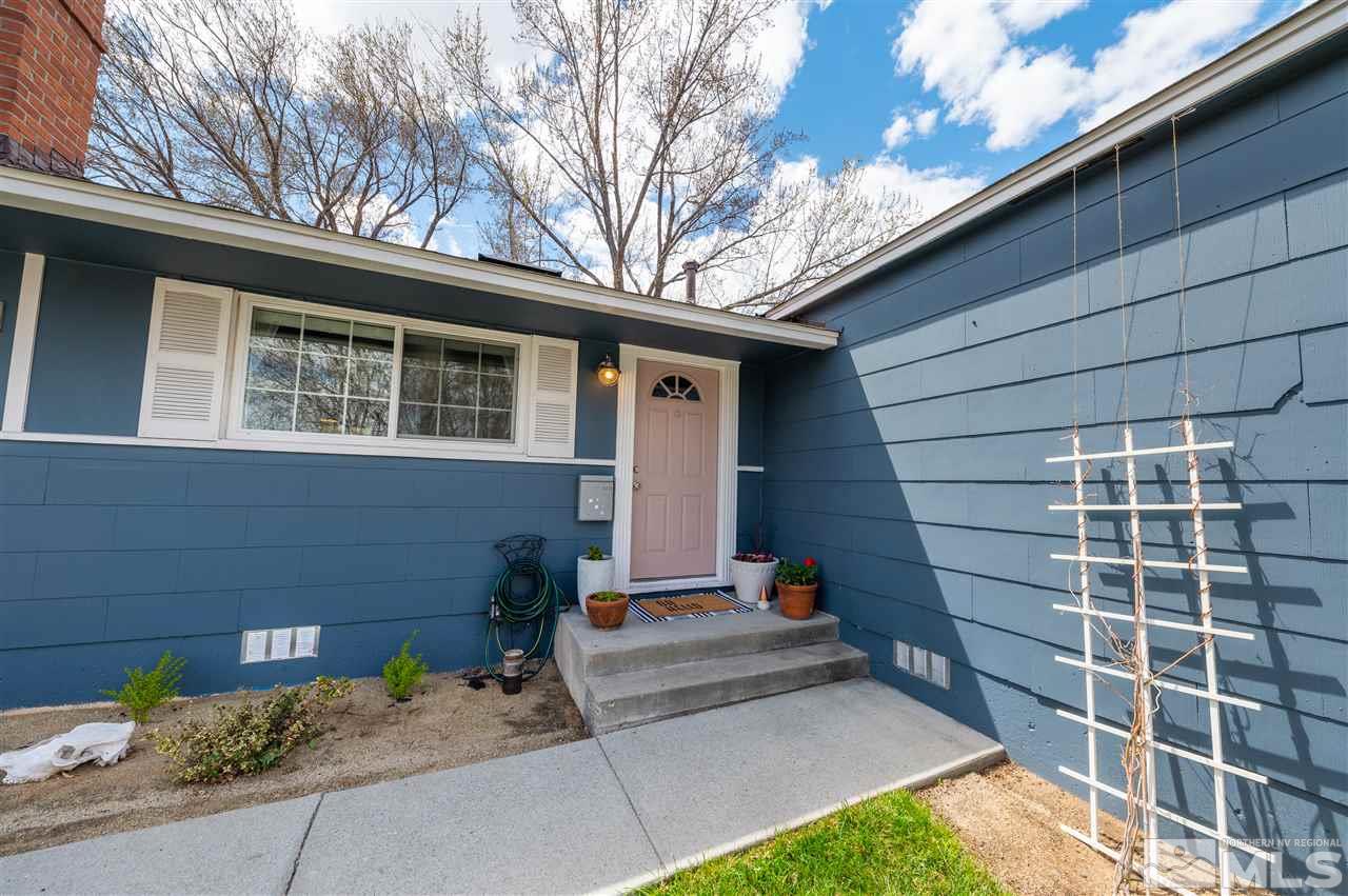 835 Ruby Avenue Reno, NV 89503 - Photo 1 of 18 a front view of a house with a garden