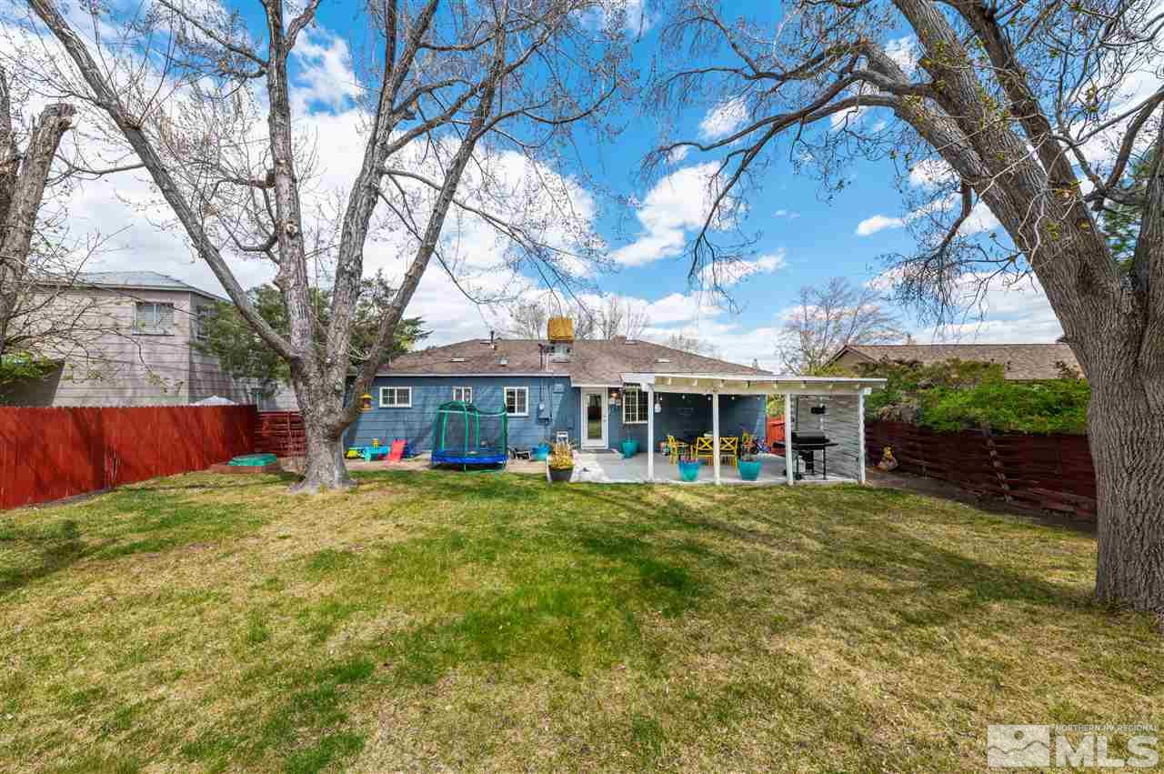 835 Ruby Avenue Reno, NV 89503 - Photo 18 of 18 a view of a house with a yard and large tree
