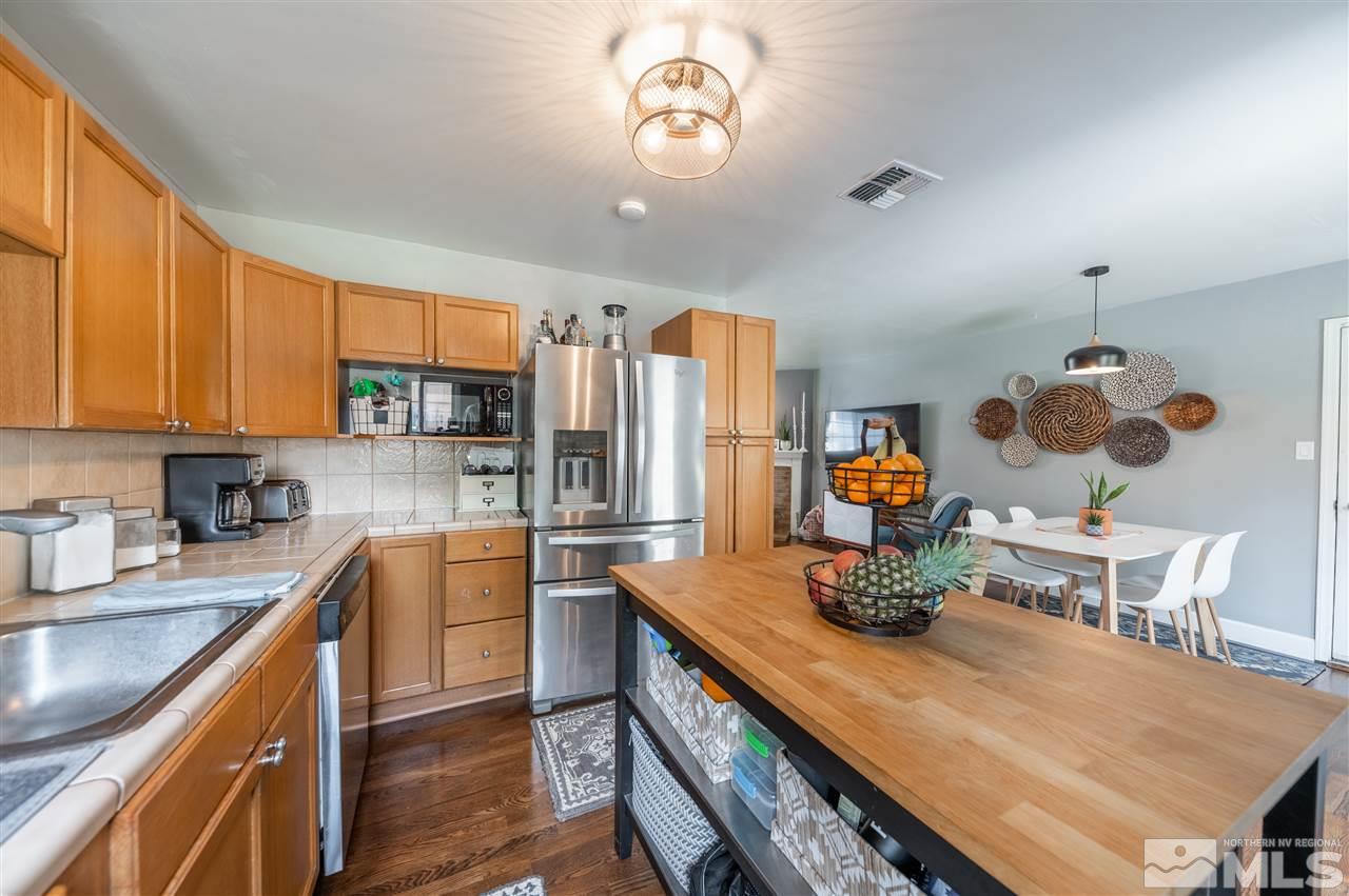 835 Ruby Avenue Reno, NV 89503 - Photo 8 of 18 a kitchen with a table chairs stove and cabinets
