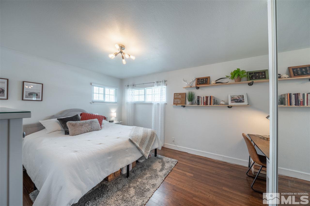 835 Ruby Avenue Reno, NV 89503 - Photo 10 of 18 a bedroom with a bed and wooden floor