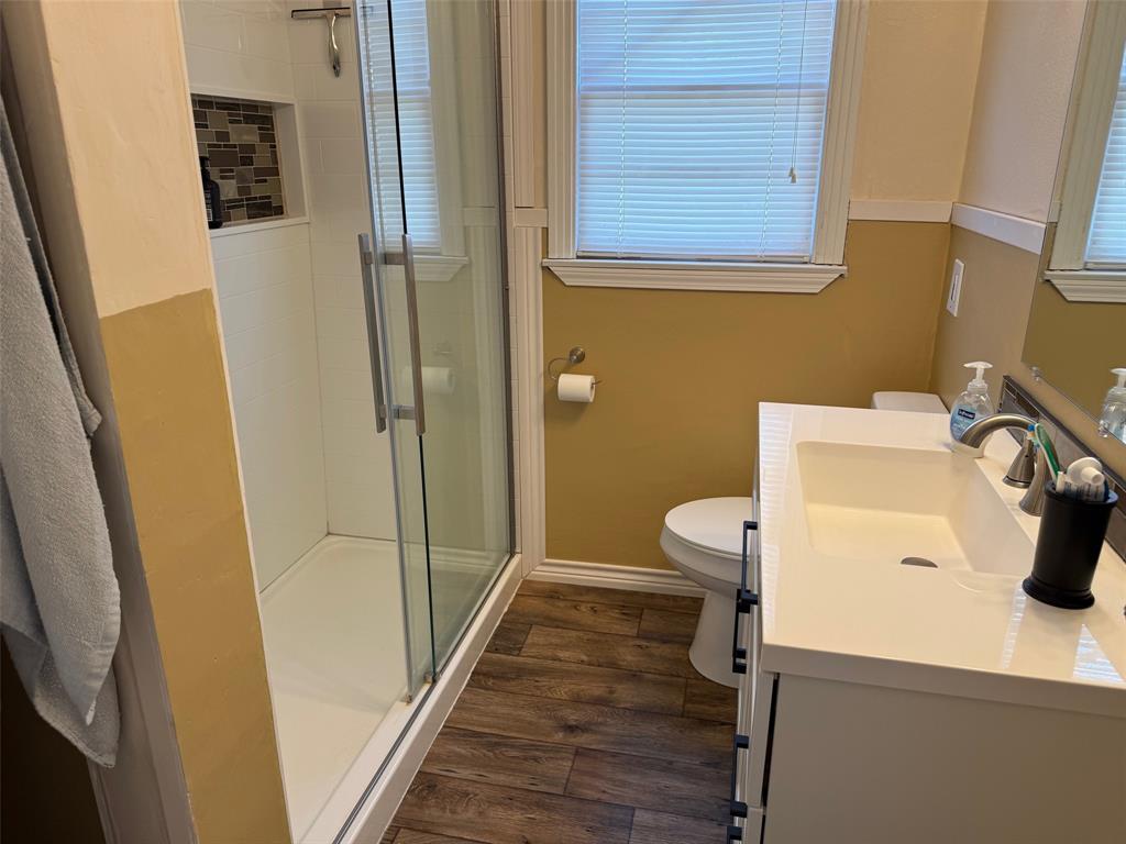 1716 Sheppard Street Waco, TX 76711 - Photo 7 of 13 a bathroom with a sink a toilet and shower