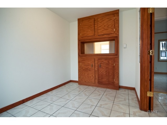 102 Louis Road Joliet, IL 60433 - Photo 4 of 10 a view of an empty room and wooden floor