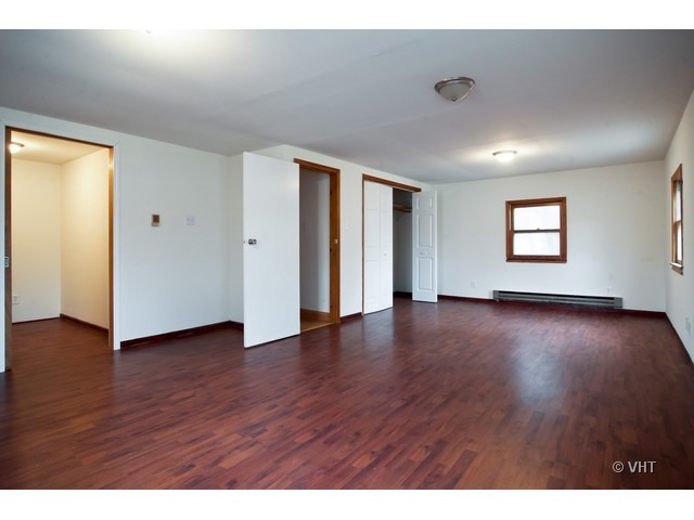 102 Louis Road Joliet, IL 60433 - Photo 6 of 10 a view of a livingroom with wooden floor and window
