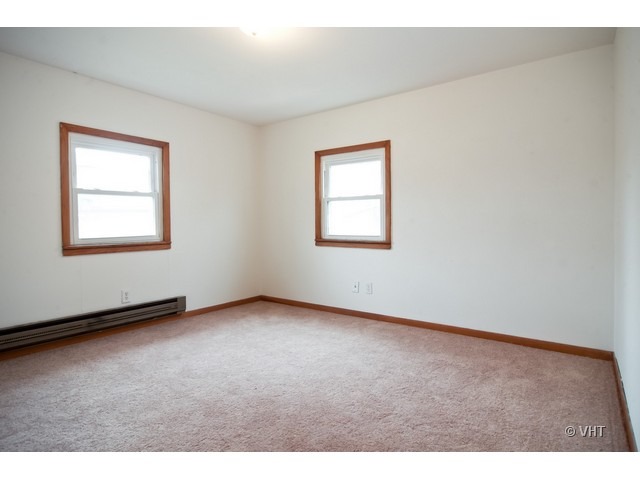 102 Louis Road Joliet, IL 60433 - Photo 8 of 10 an empty room with windows