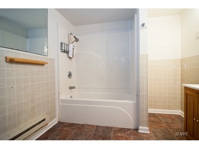 102 Louis Road Joliet, IL 60433 - Photo 9 of 10 a bathroom with a bathtub and a shower