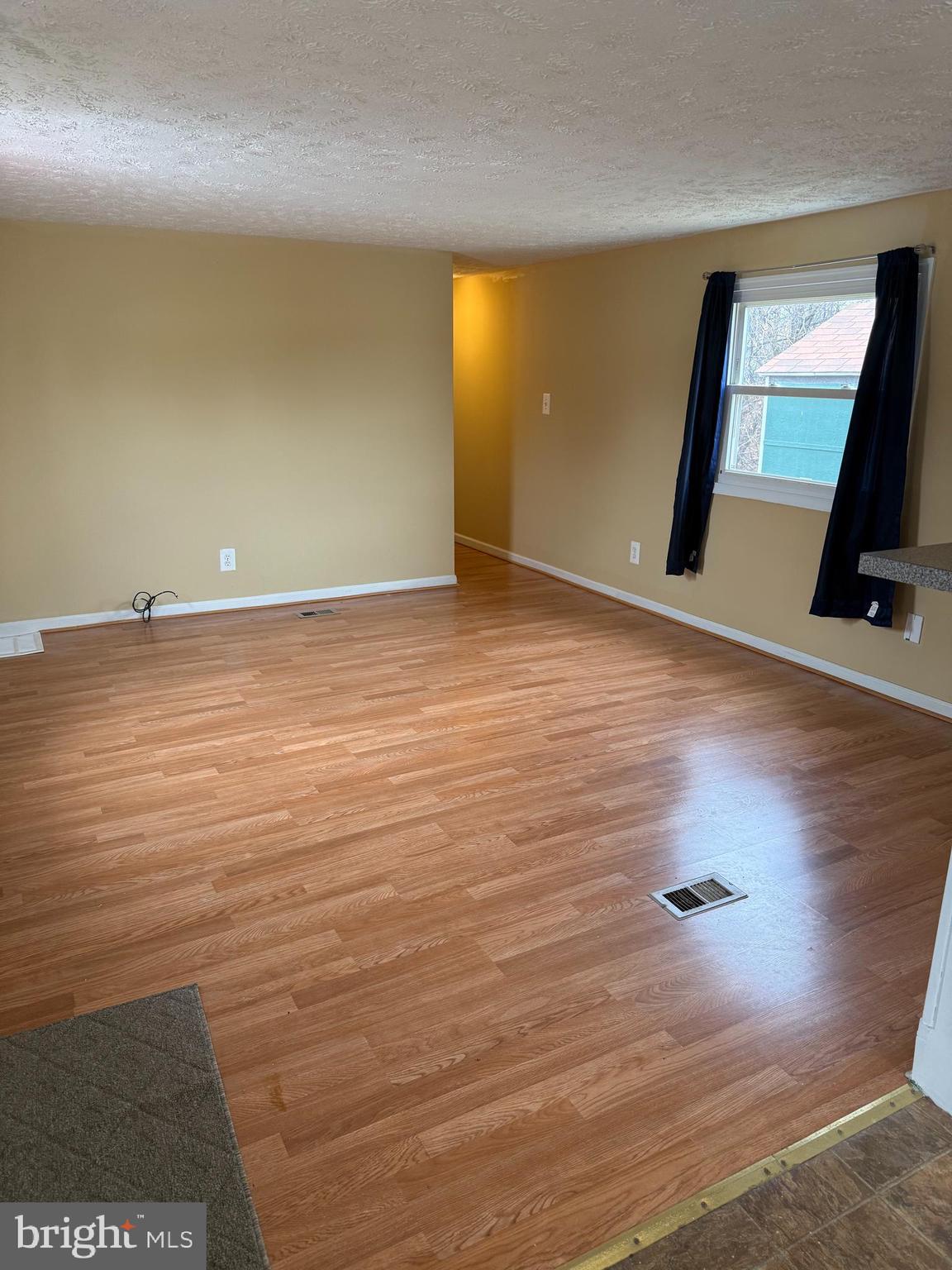 478 Mirabile Lane Baltimore, MD 21224 - Photo 13 of 23 a view of a room with wooden floor and a window
