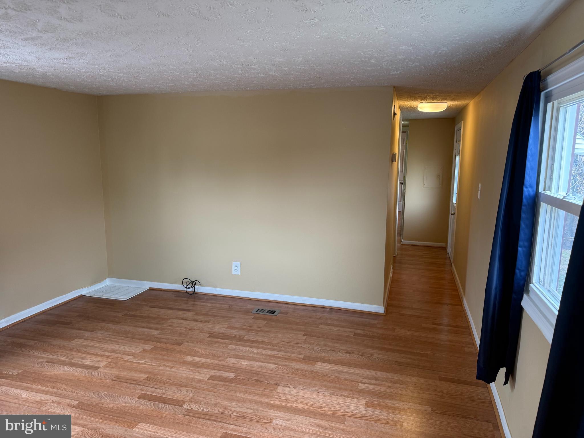 478 Mirabile Lane Baltimore, MD 21224 - Photo 14 of 23 a view of an empty room with wooden floor and a painting
