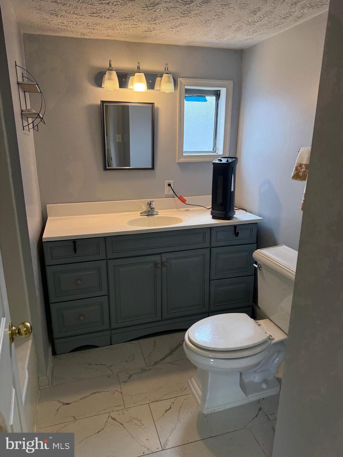 478 Mirabile Lane Baltimore, MD 21224 - Photo 20 of 23 a bathroom with a toilet sink and mirror