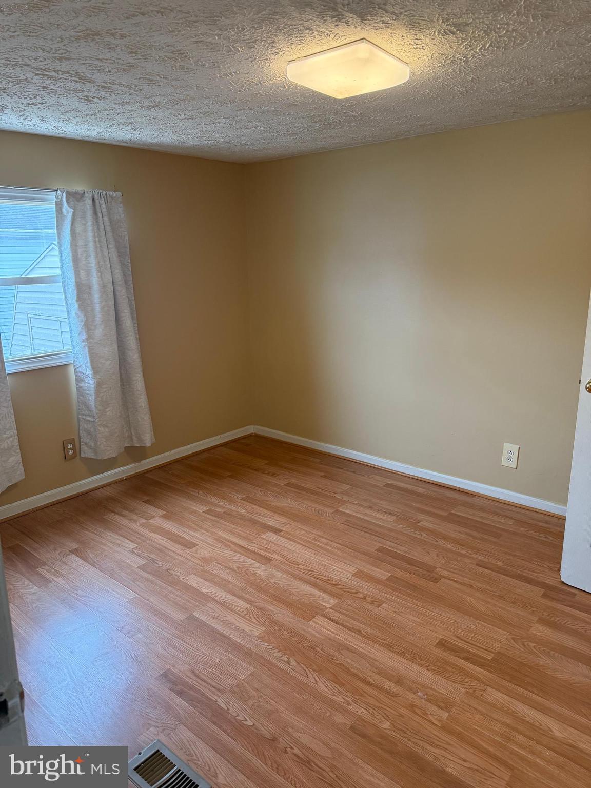 478 Mirabile Lane Baltimore, MD 21224 - Photo 21 of 23 a view of an empty room and wooden floor