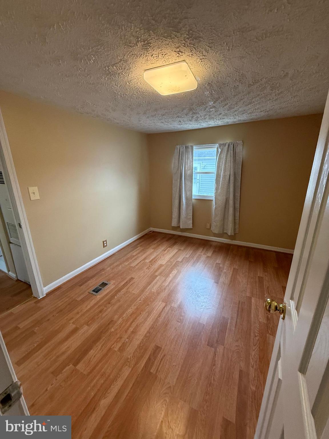 478 Mirabile Lane Baltimore, MD 21224 - Photo 23 of 23 a view of room with window and hardwood floor