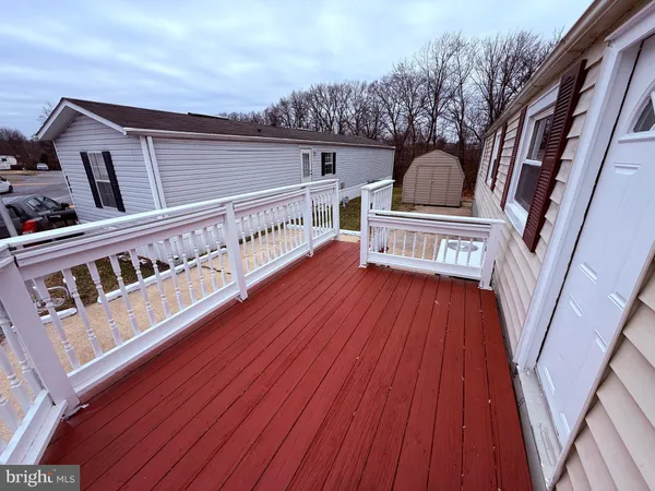 a view of balcony with wooden floor and fence