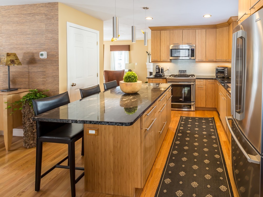 4 Hawthorne Road Wayland, MA 01778 - Photo 3 of 18 a kitchen with stainless steel appliances granite countertop a sink and a refrigerator