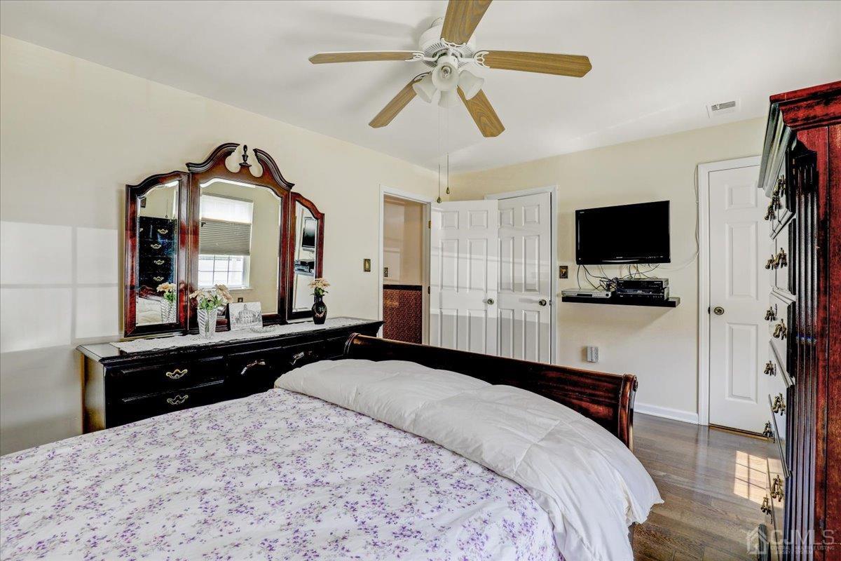 95 Neilly Court Old Bridge, NJ 08857 - Photo 17 of 35 a bedroom with a bed a window and a flat screen television