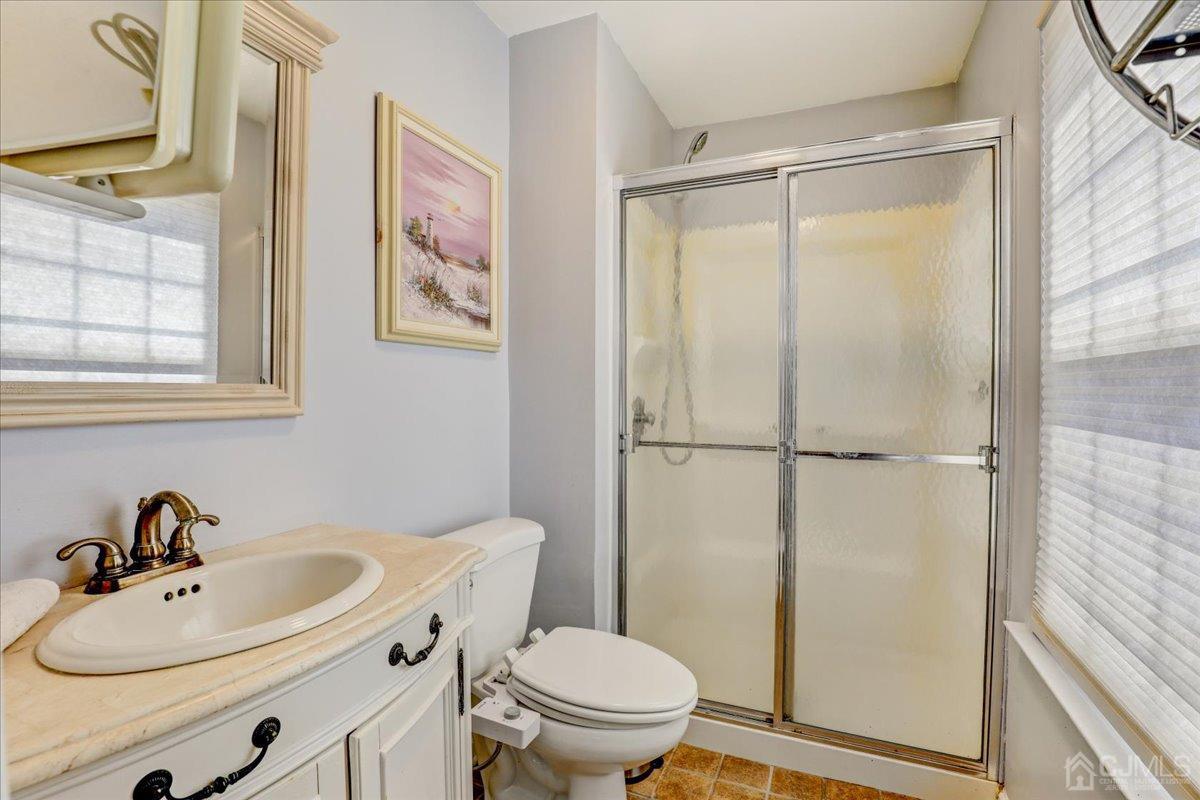 95 Neilly Court Old Bridge, NJ 08857 - Photo 18 of 35 a bathroom with a sink a toilet and a mirror