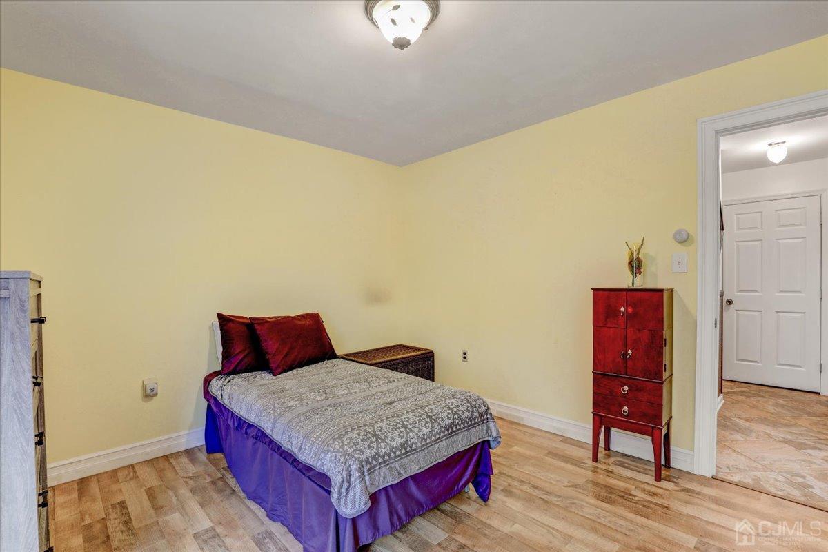95 Neilly Court Old Bridge, NJ 08857 - Photo 20 of 35 a bedroom with a bed and wooden floor