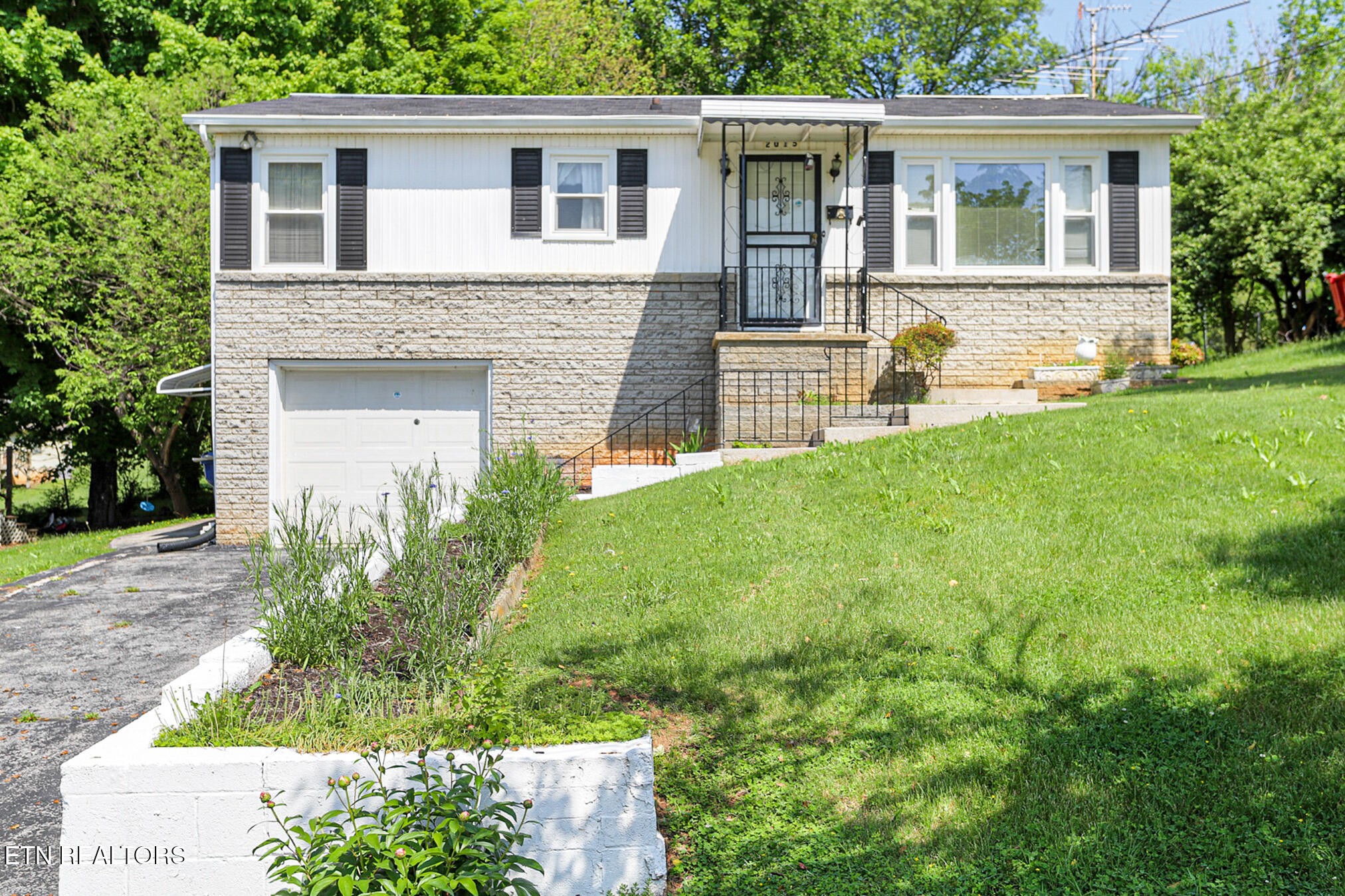 a front view of a house with garden