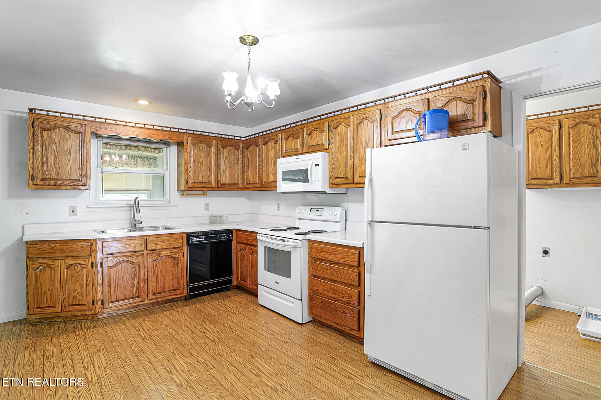 2015 Carolyn Drive Jefferson City, TN 37760 - Photo 14 of 44 a kitchen with stainless steel appliances granite countertop a refrigerator a stove a sink dishwasher and a refrigerator with wooden floor